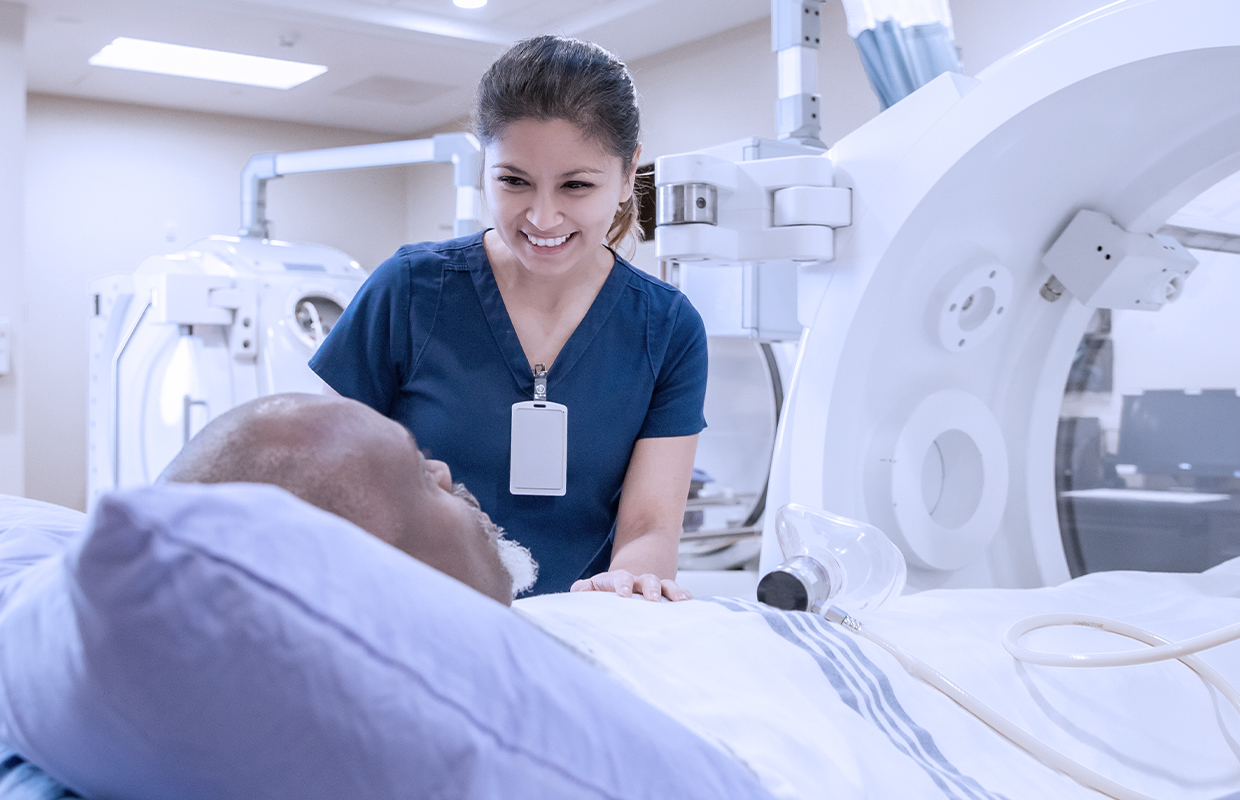 female nurse talking to a patient before undergoing radiation