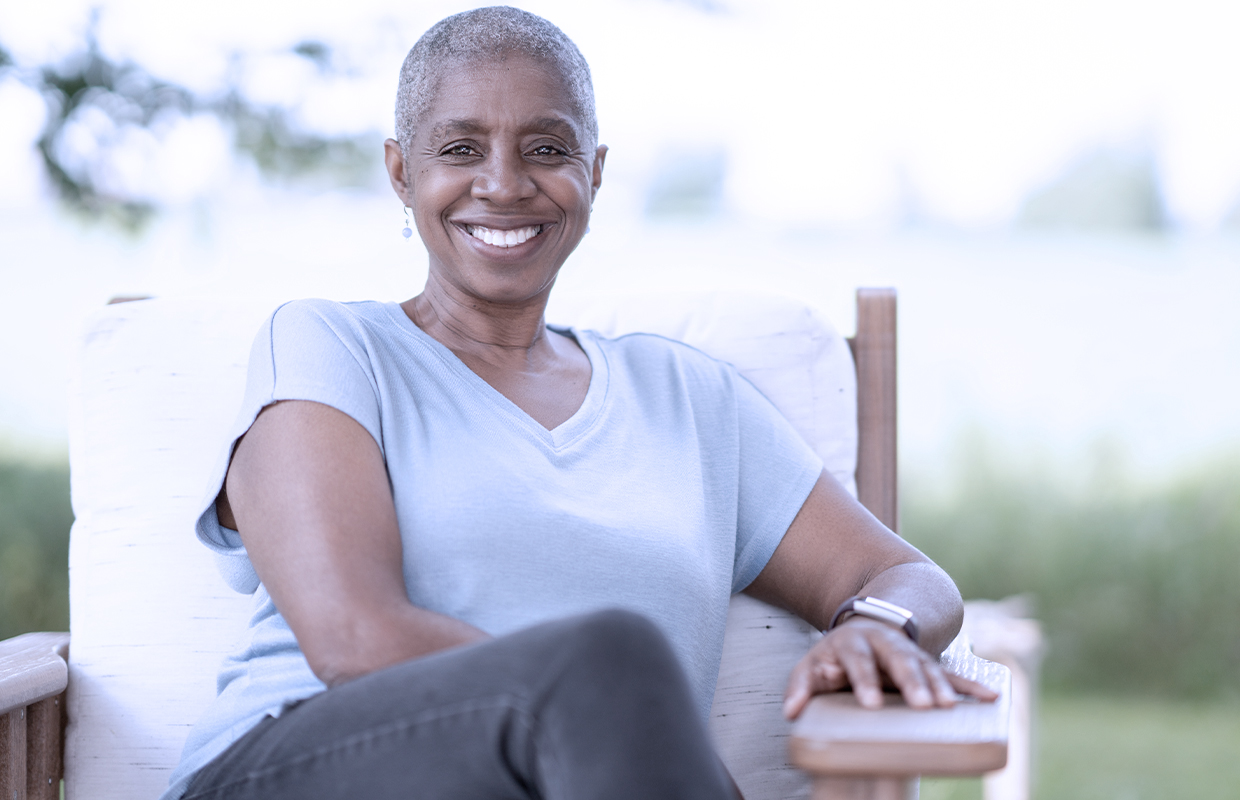 middle age woman sitting outside smiling