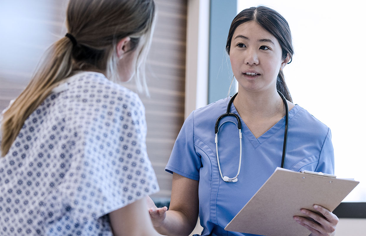 Young mother talks with a friendly nurse in the labor and delivery unit at Covenant Health.