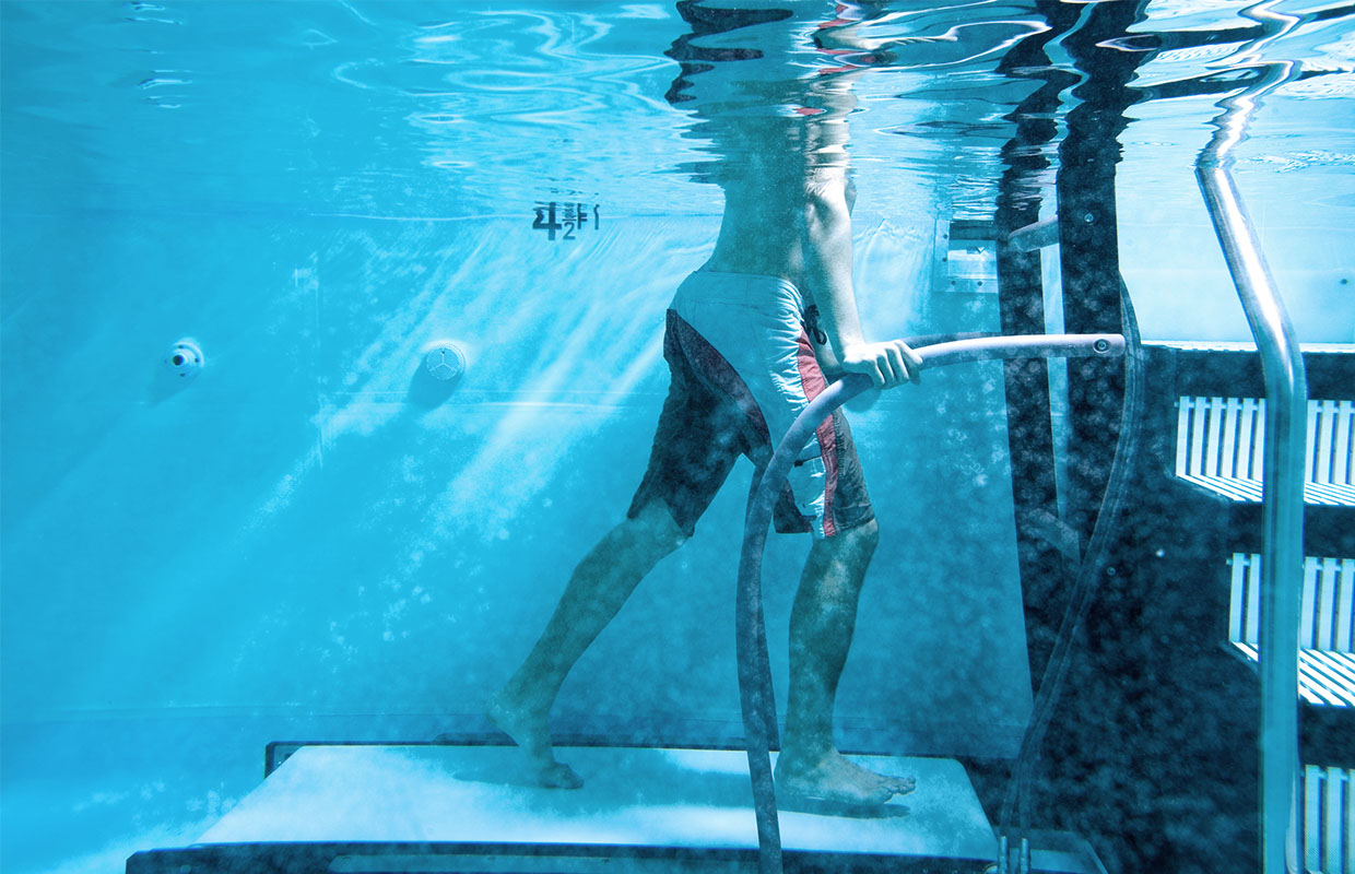 person completing aquatic therapy on an underwater treadmill