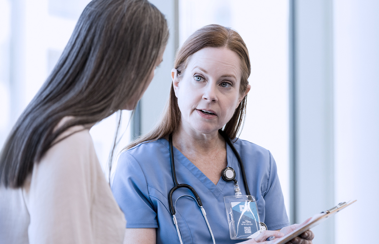 Female nurse explains to a patient what she can expect as part of her MRI exam.