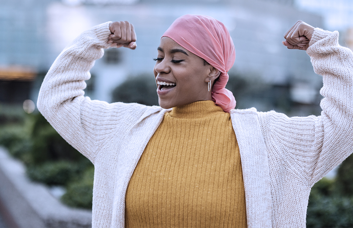 middle age woman lifting her arms in triumph