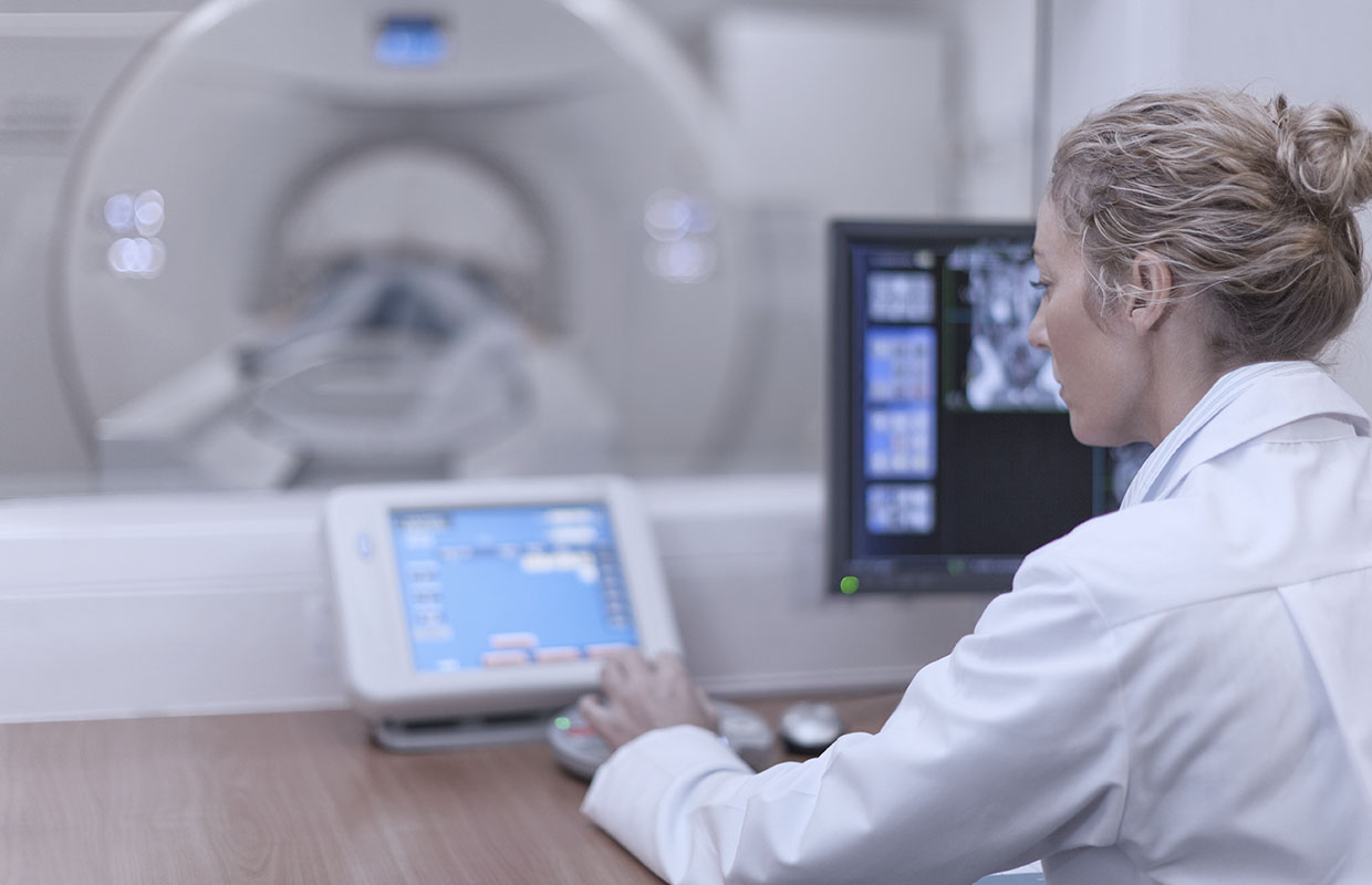 Physician uses technology to operate CT scan for lung cancer patient.