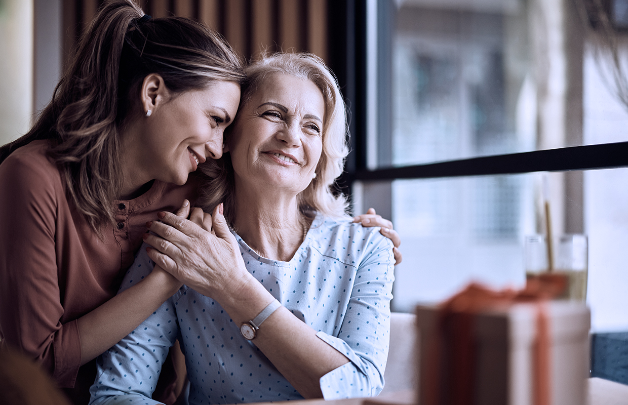 adult female hugging her senior mother