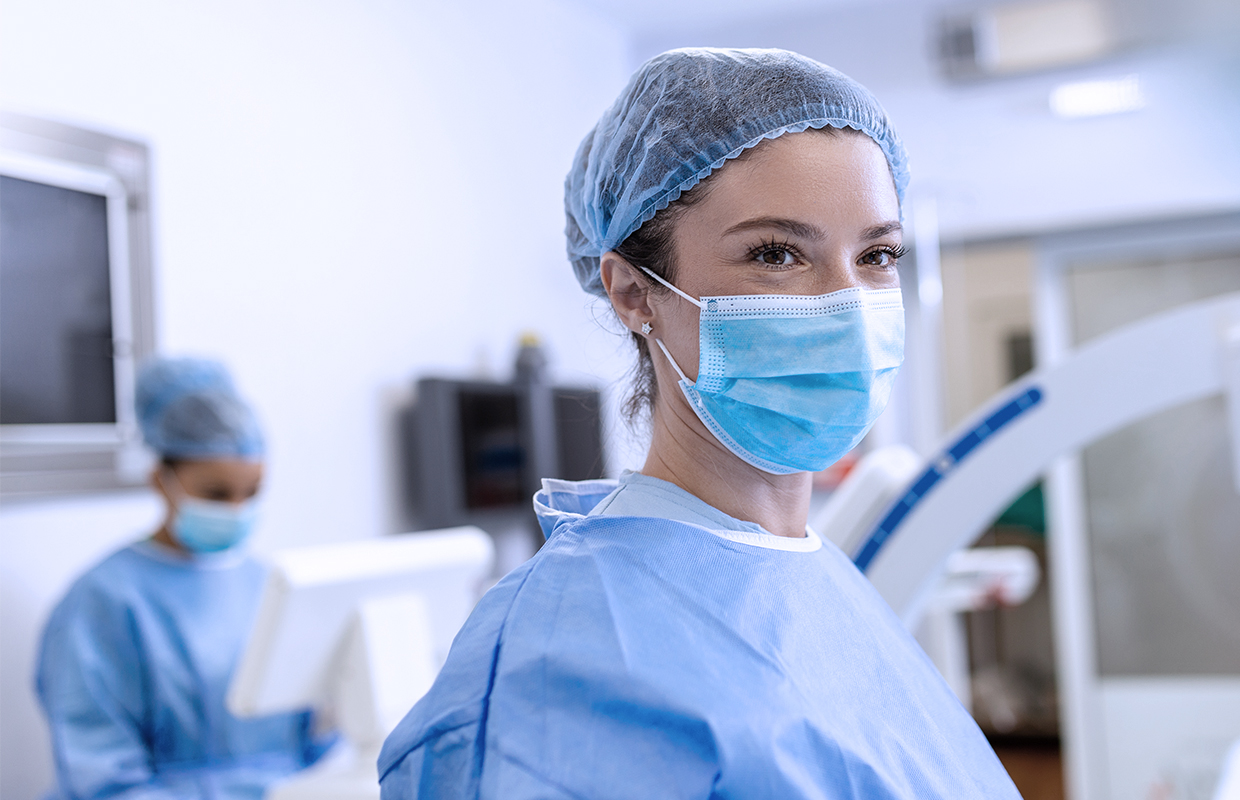 female surgeon in scrubs and surgical mask