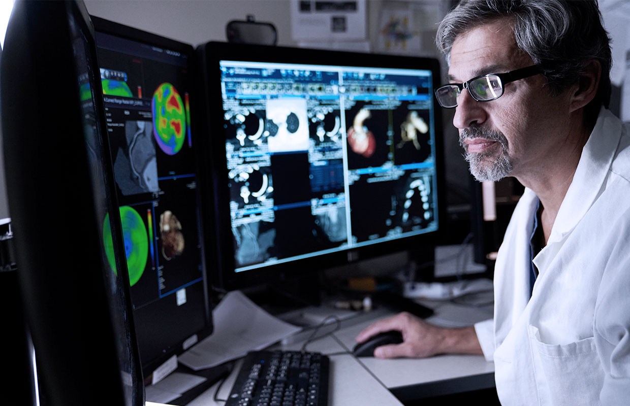 doctor looks at diagnostic imaging results on computer screen