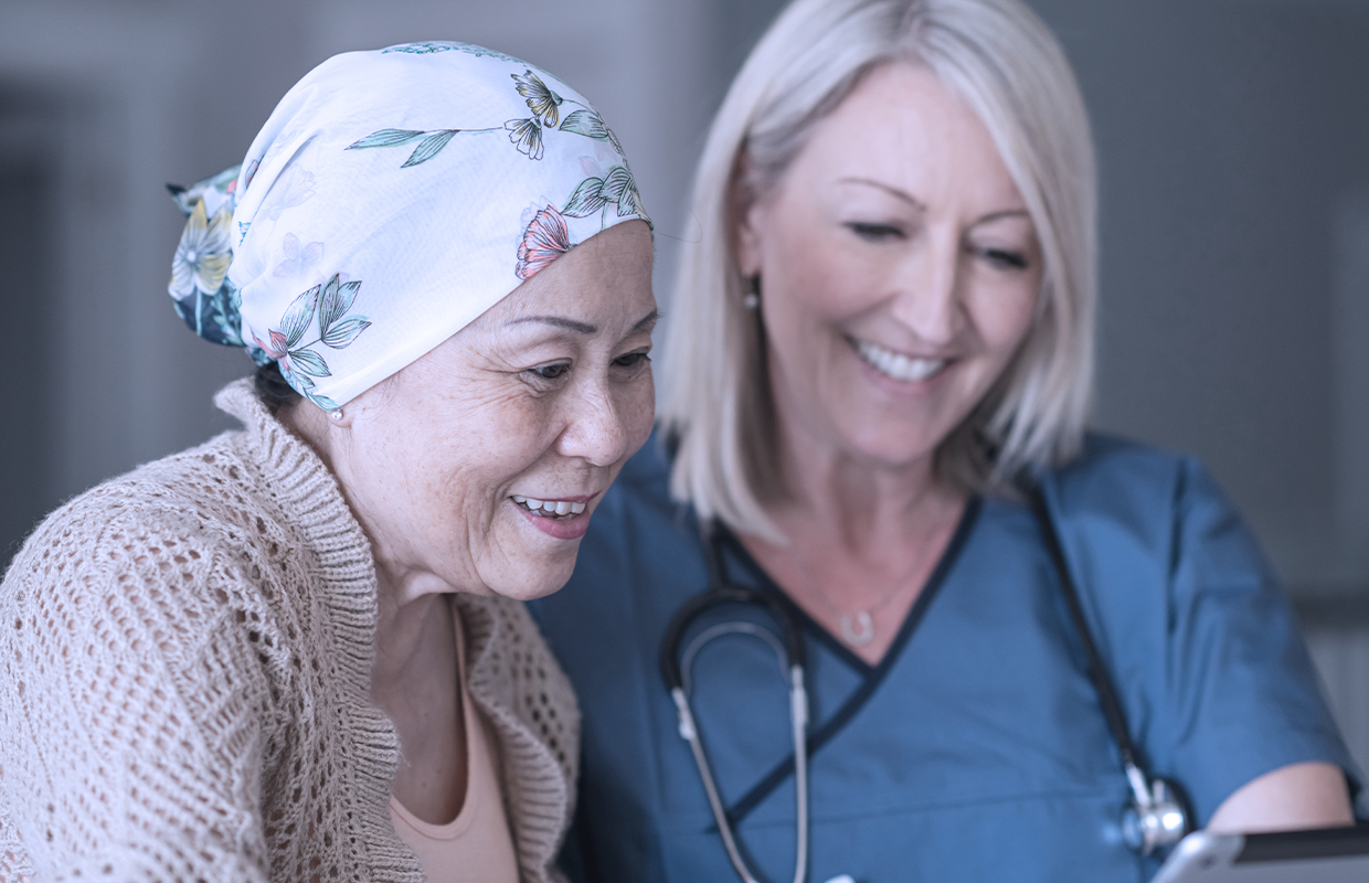 Nurse meets with cancer patient to answer questions.