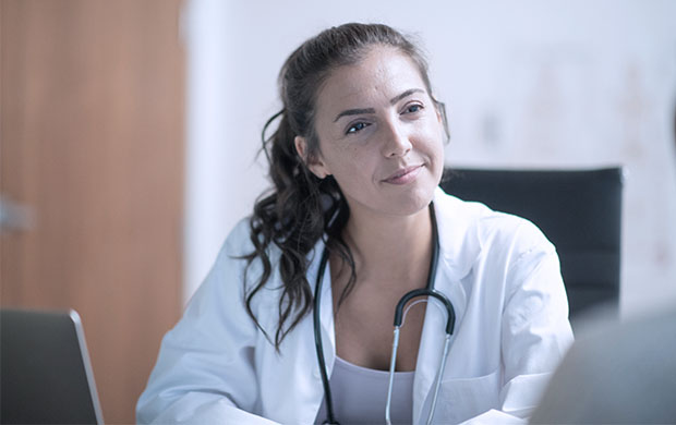 covenant health primary care doctor sits at desk