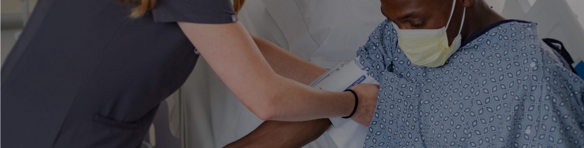 covenant health nurse adjusting blood pressure cuff on patient