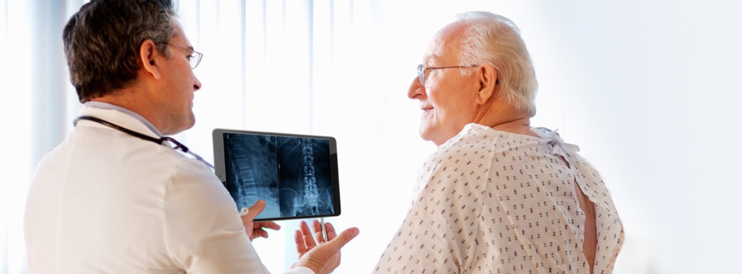 middle age doctor showing xray to elderly male patient