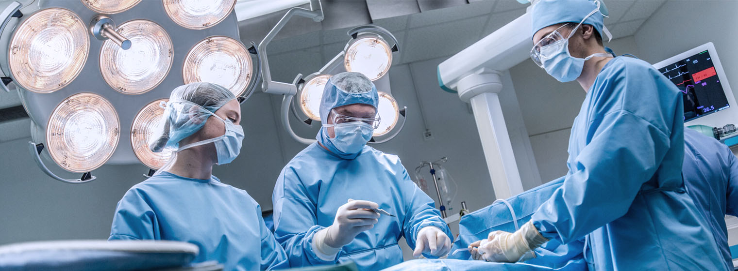 group of three surgeons performing a surgery