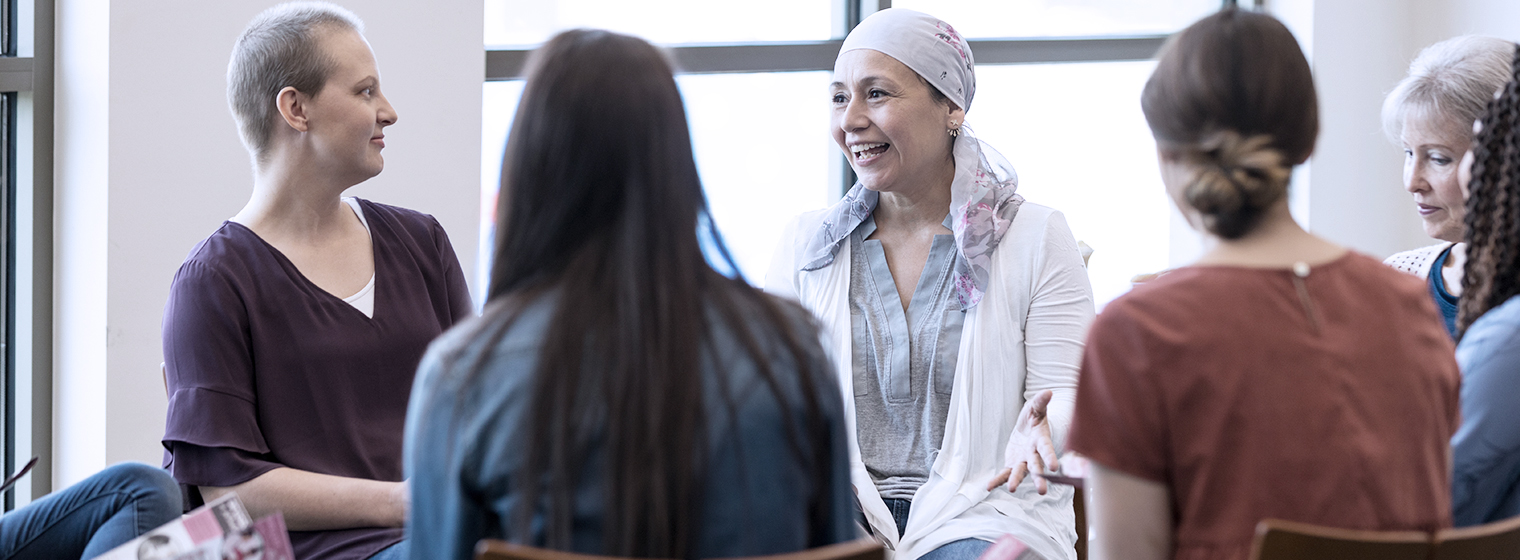 Group of cancer patients sit in a circle at a support group.