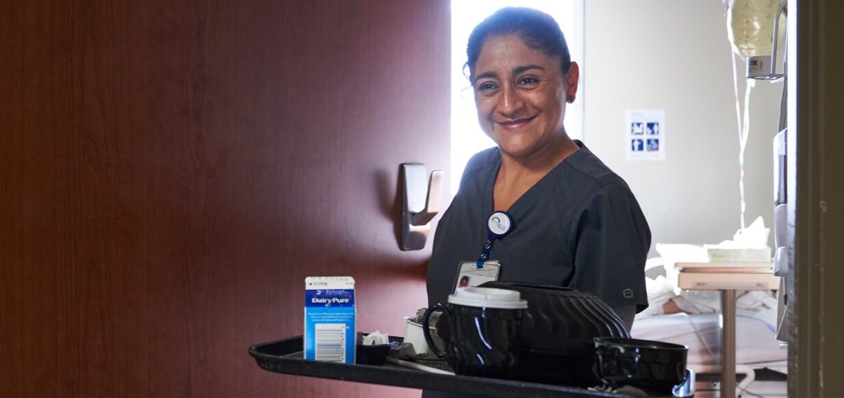 nurse carrying tray