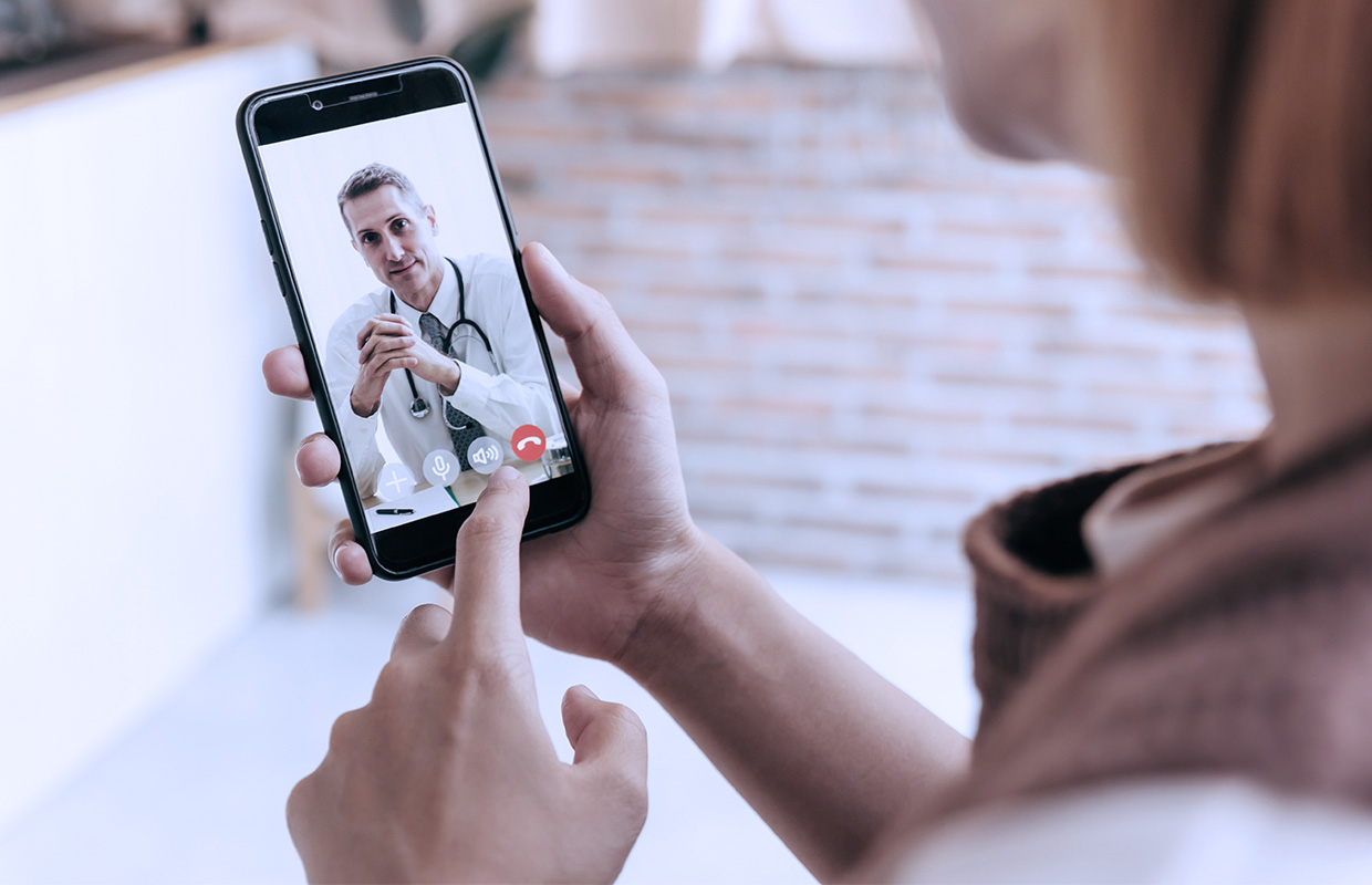 woman facetiming on phone to male doctor