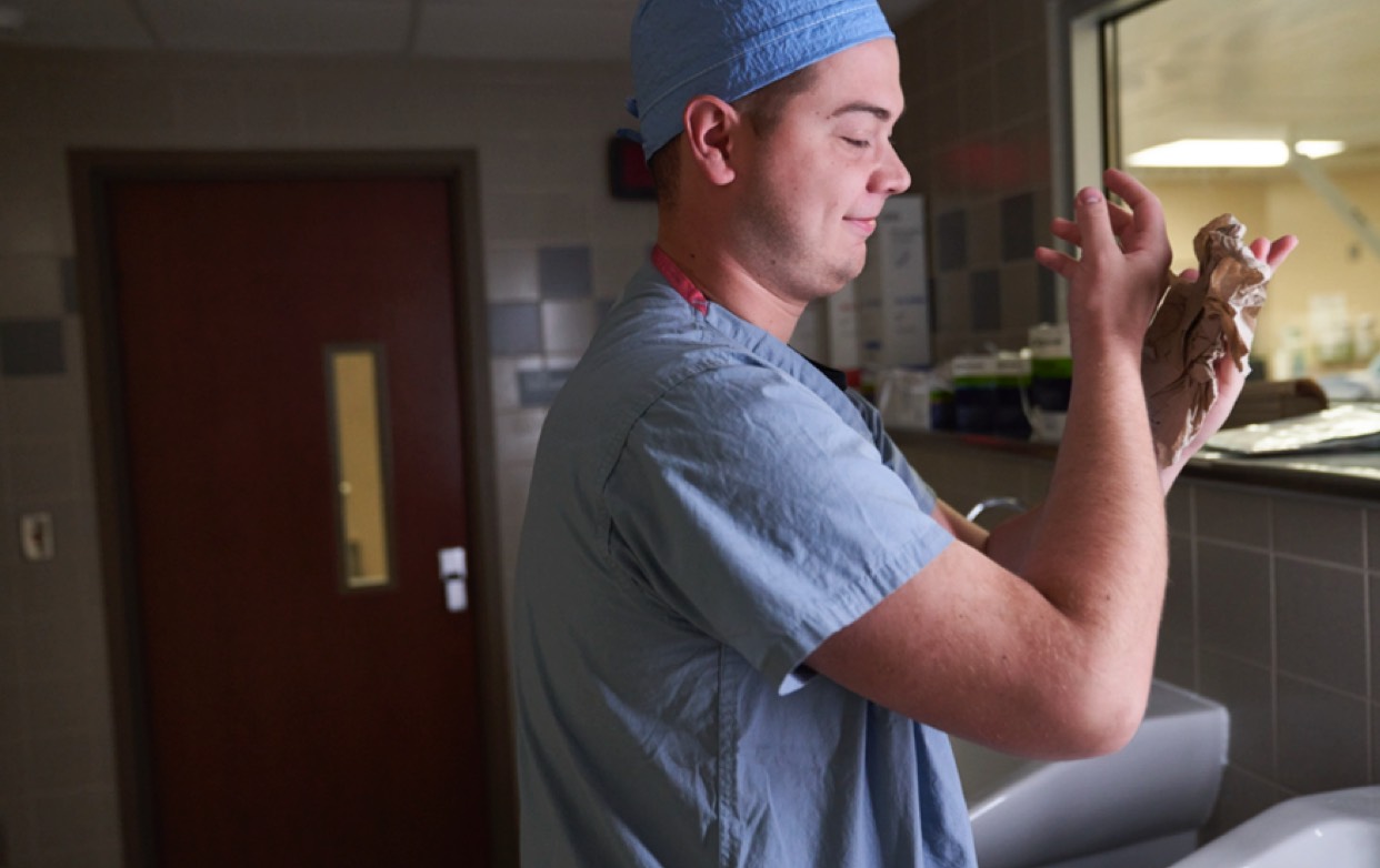 Surgeon drying his hands