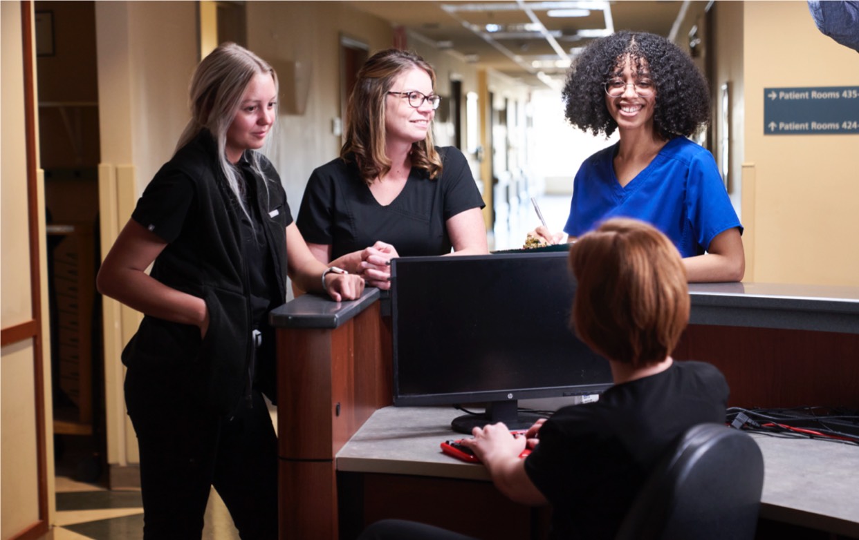 Medical staff smiling and talking to each other in the hospital