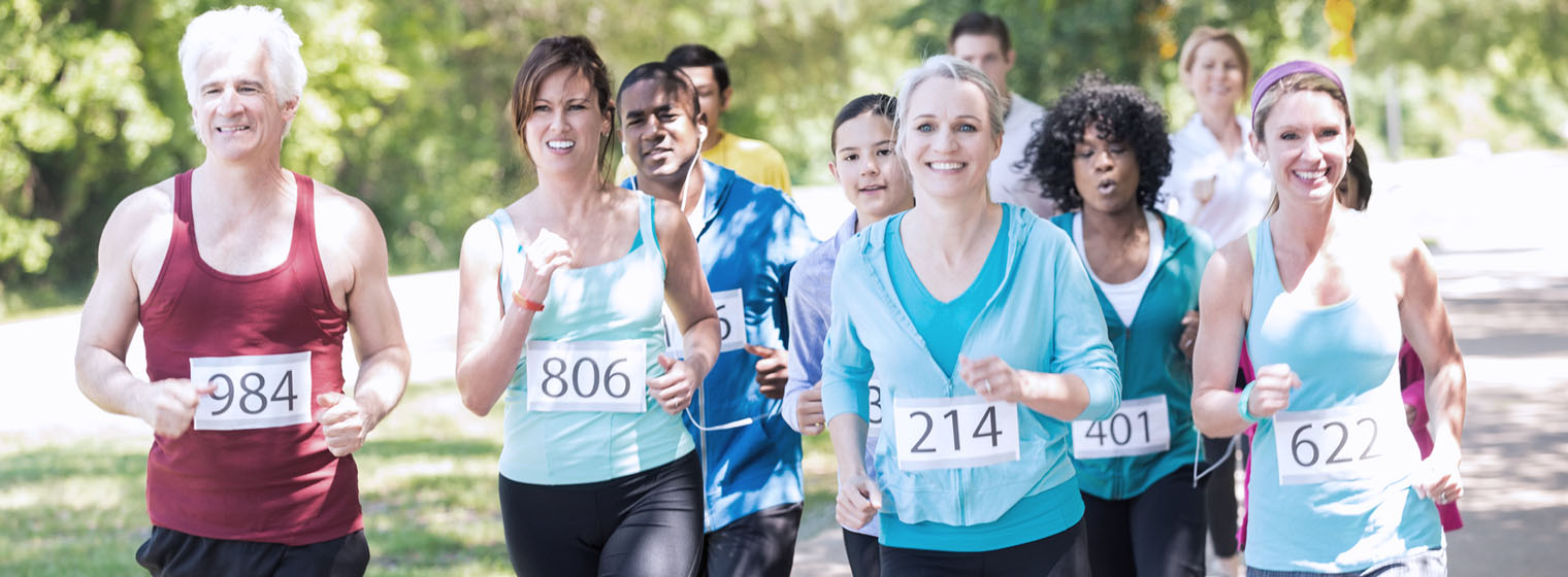 a group of people running a road race