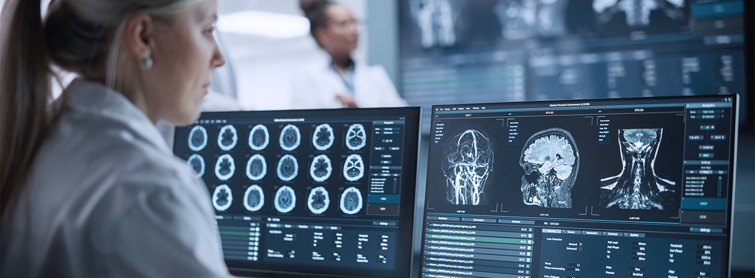 female physician looking at x-ray results on computer screen