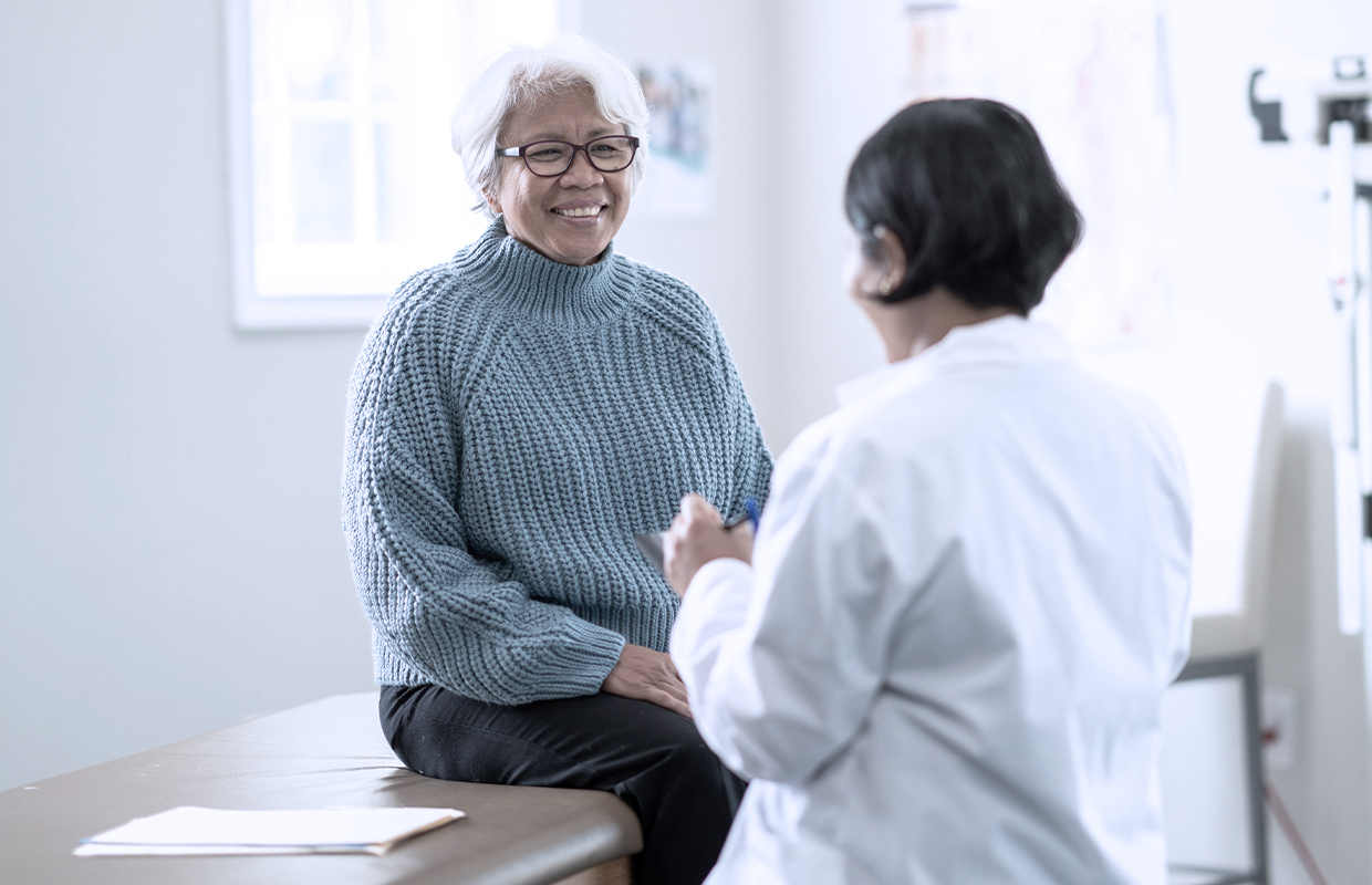 Female healthcare provider talks to middle aged female about the benefits of a low-dose lung cancer screening.