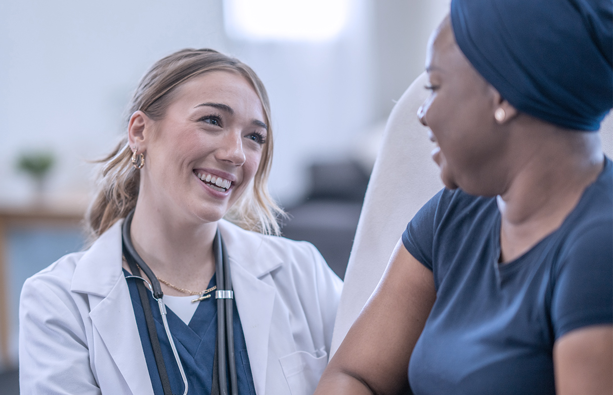 young female doctor talking to female patient