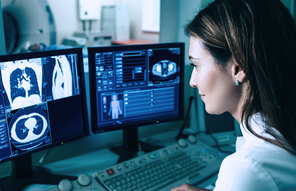 Physician examines CT scan of lungs to look for signs of lung cancer.