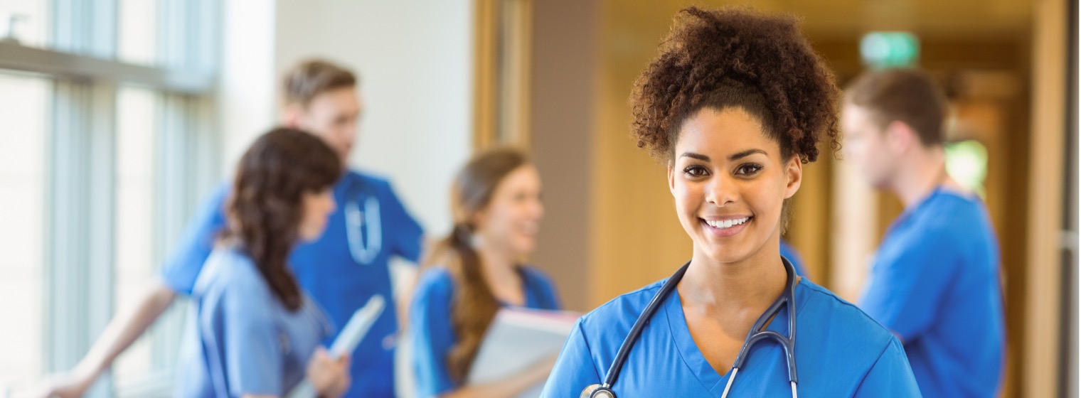 female medical student smiling with group of other students behind her