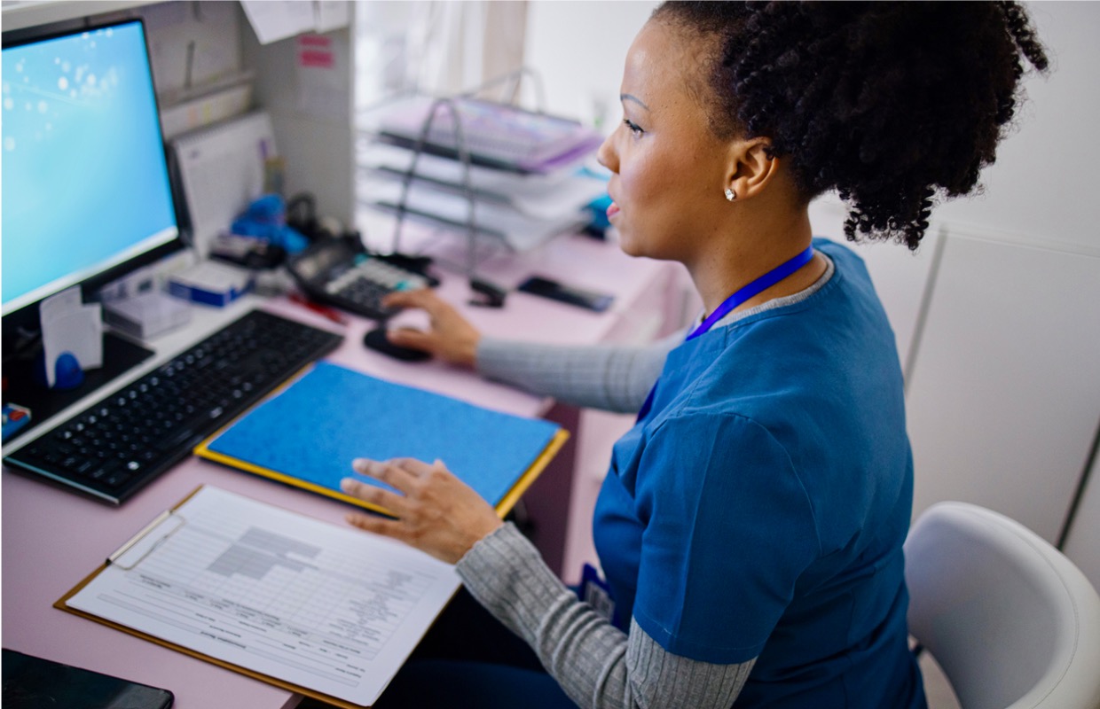 female nurse working at a computer station