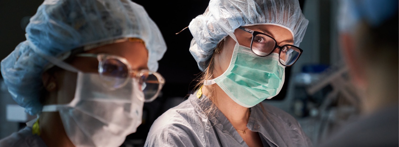 two surgeons in scrubs and masks in operating room