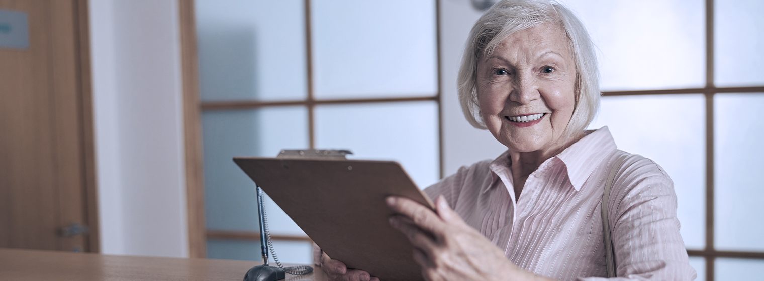 Woman holding clipboard and smiling