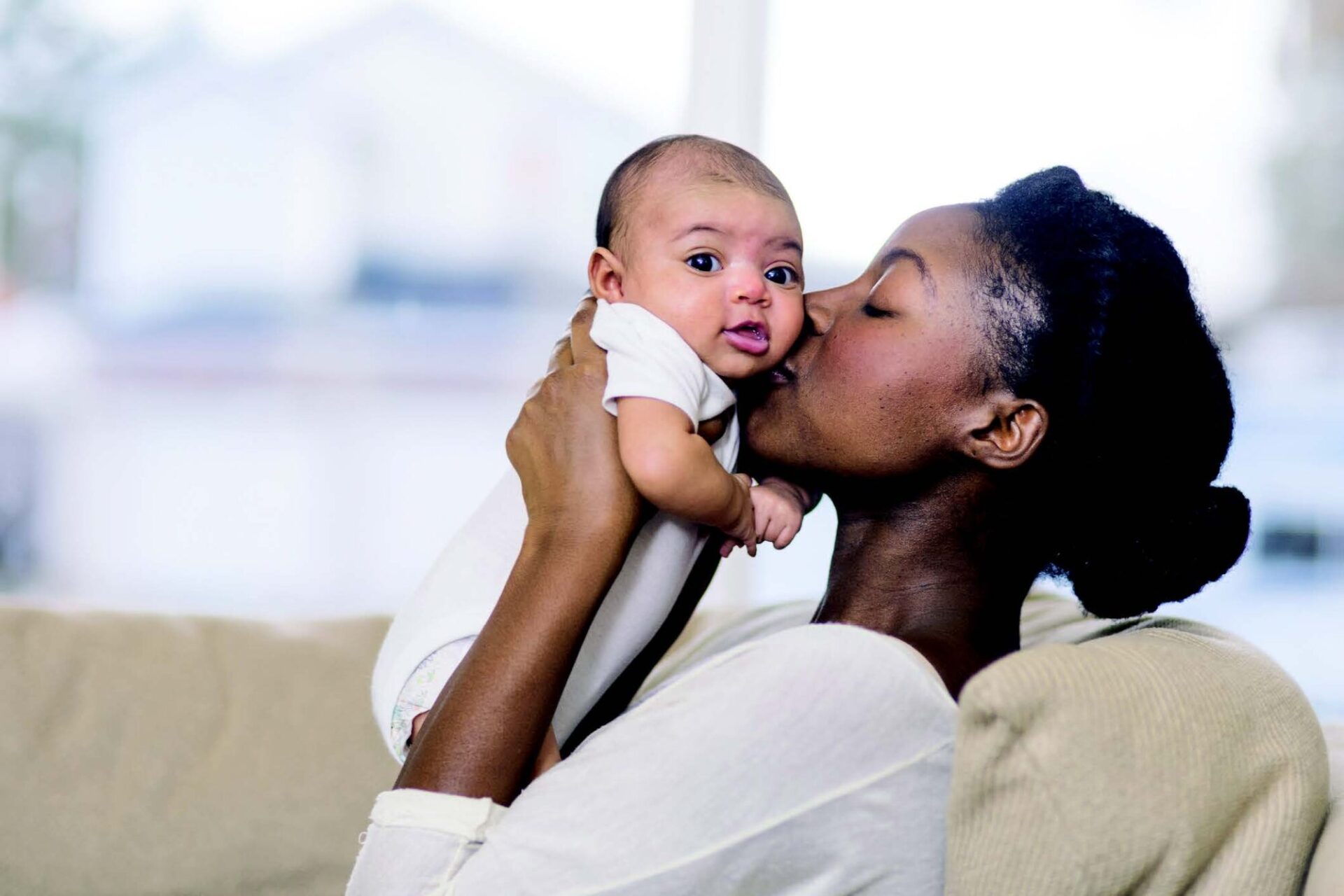 mother kissing baby