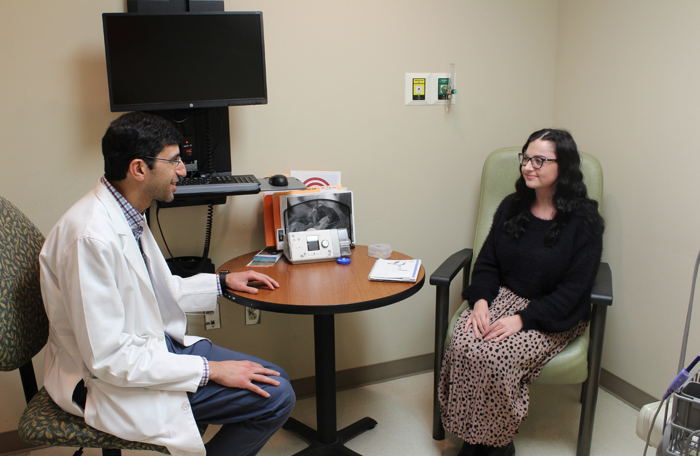 Dr. Alsharif talking with patient in sleep center
