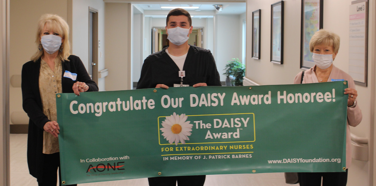 0813-3155 WSSN Daisy Award - 8-19-20 Matt Ryan pictured with DAISY banner held by the sisters who nominated him.