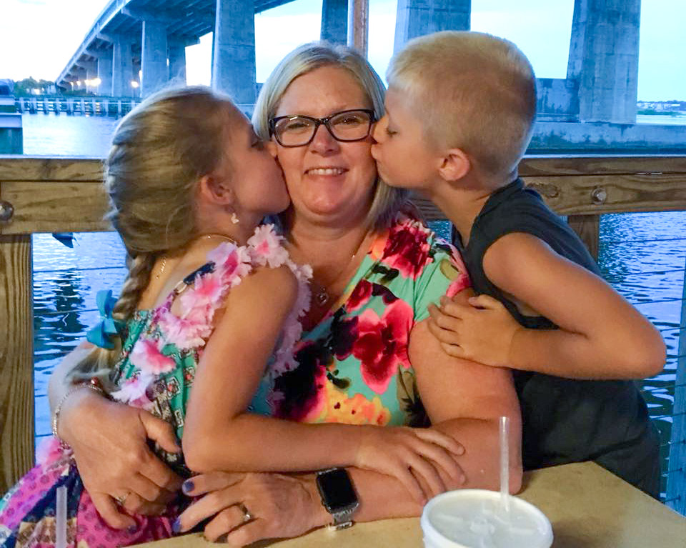 Carla fields gets a kiss from her twins.