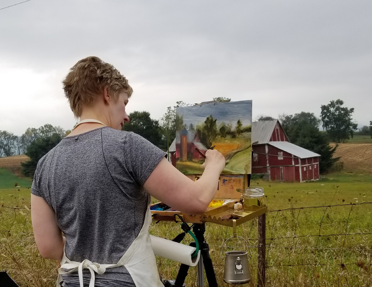 sarah Pollock painting in field.