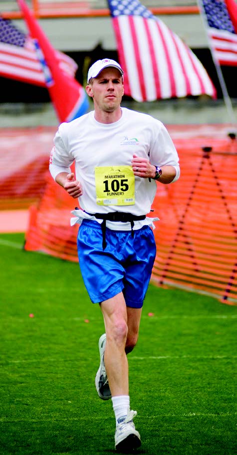 Mark Conley crossing finish line at marathon.