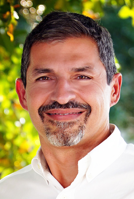 Headshot of Dr. Emanuel in white collared shirt.
