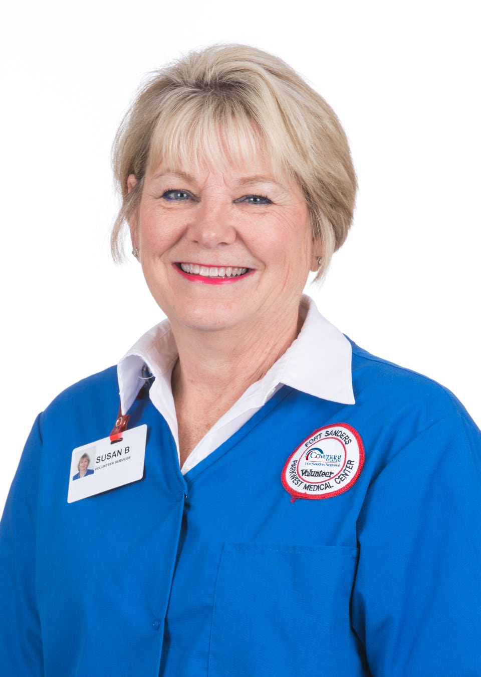 Headshot of Susan Brown smiling, wearing blue volunteer jacket.