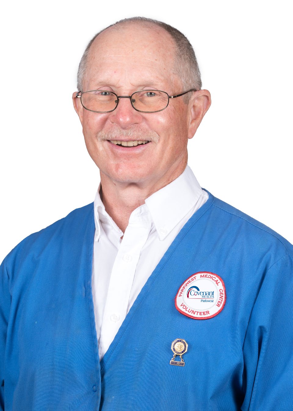 Headshot of Andy Weaver smiling, wearing blue volunteer jacket.