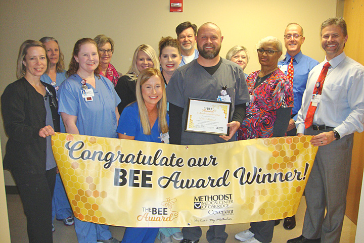 BEE Award Honoree Eric Shepard is surrounded by co-workers and leadership during his presentation.
