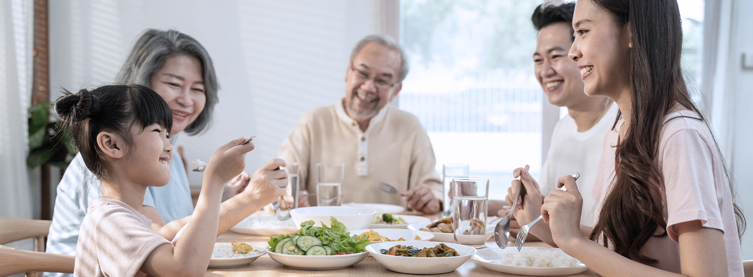 family of three generations eating around a table