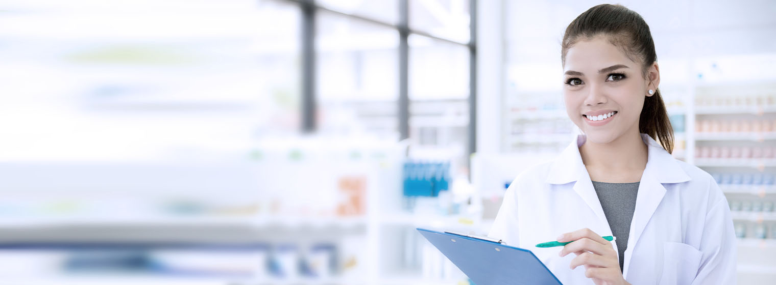 female pharmacy student smiles in laboratory