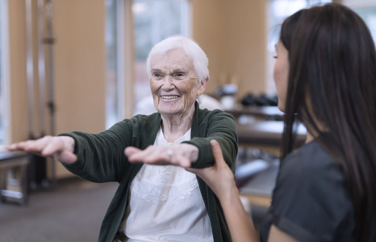 elderly female patient completes physical therapy