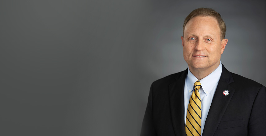 headshot of Jim VanderSteeg, president and CEO of Covenant Health, on gray background