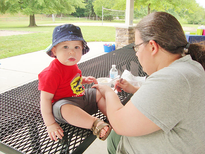 Baby enjoying a sweet summer treat with his mom