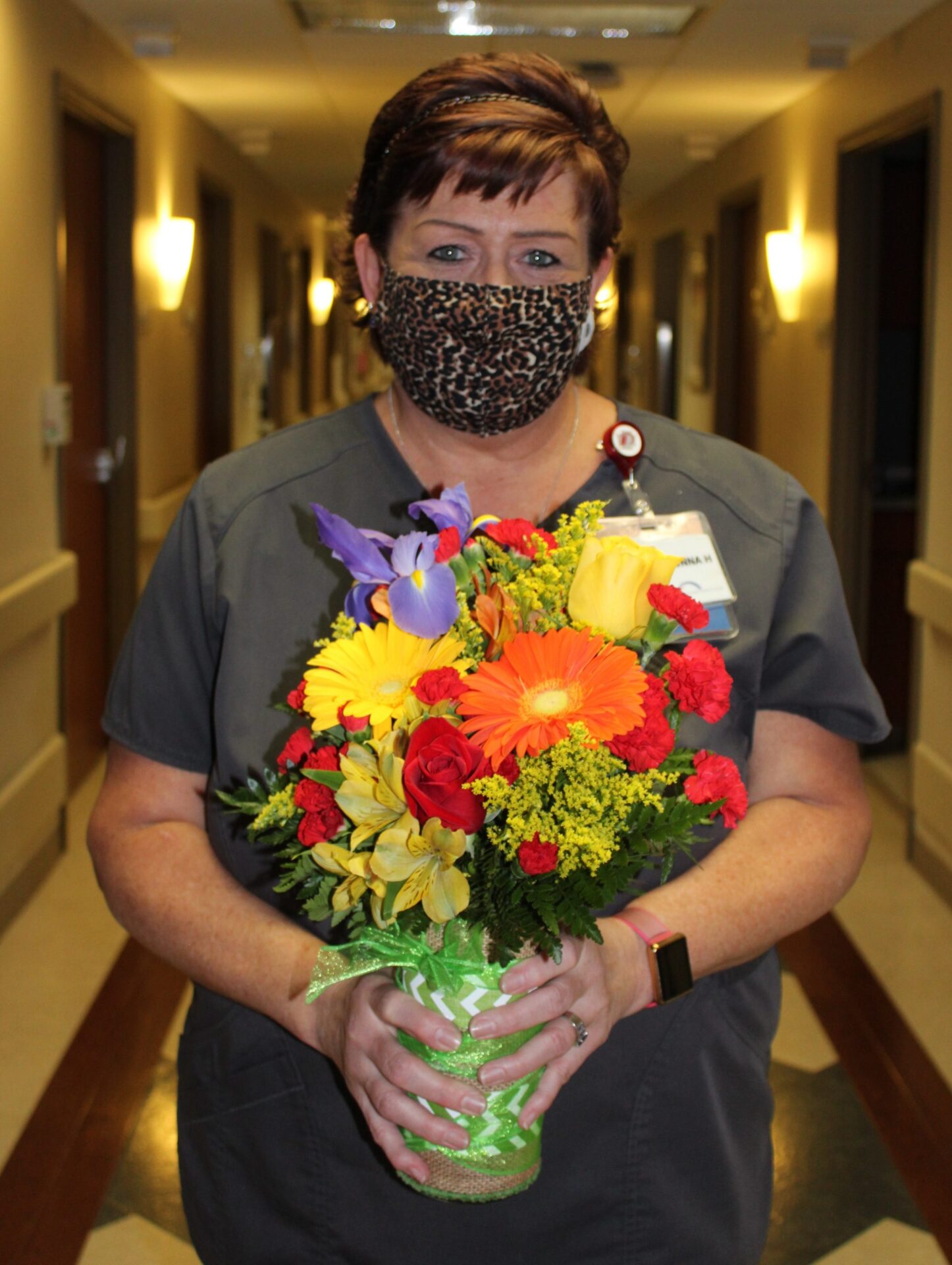 Shawwna Hale holding flowers, wearing mask