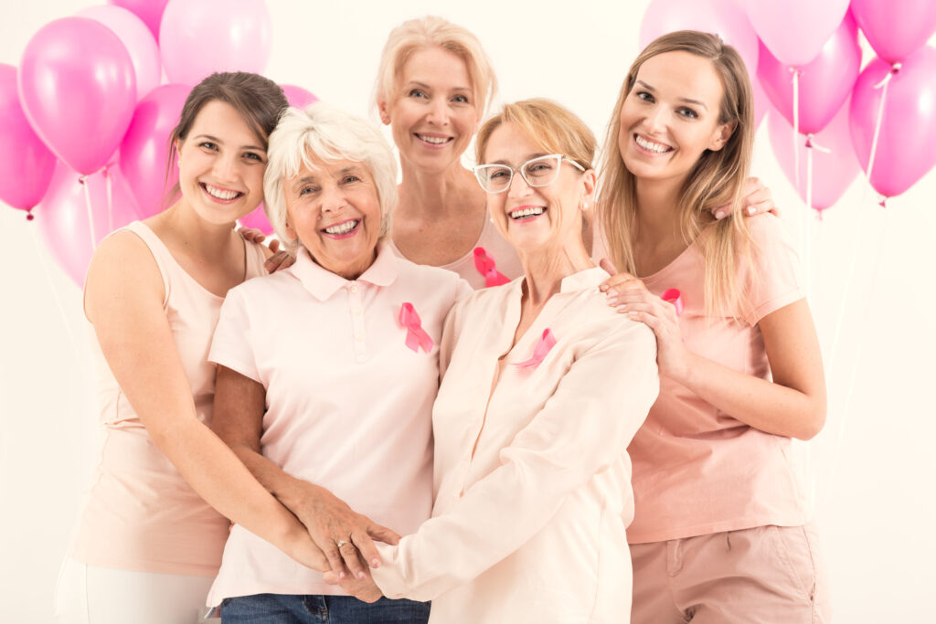 multi generations of women in pink standing in front of pink balloons