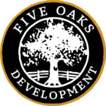 A circular logo with a large white oak tree and a fence in the center, surrounded by the words FIVE OAKS DEVELOPMENT in uppercase letters on a black background with a gold outer border, perfect for a sporting clays tournament event.