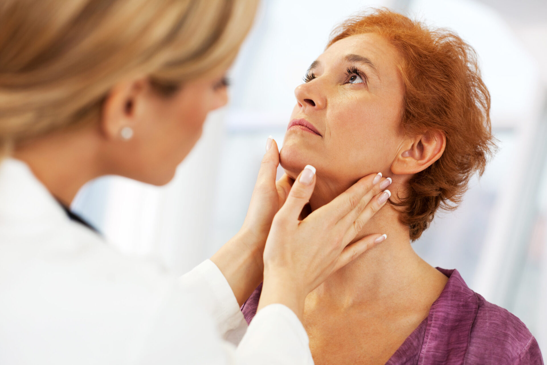 doctor examining a woman's throat