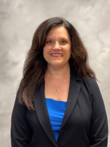 Heashot of NIkki Benner in royal blue shirt & black blazer.