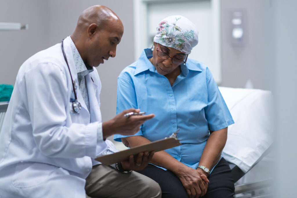 male physician discusses care plan with female patient